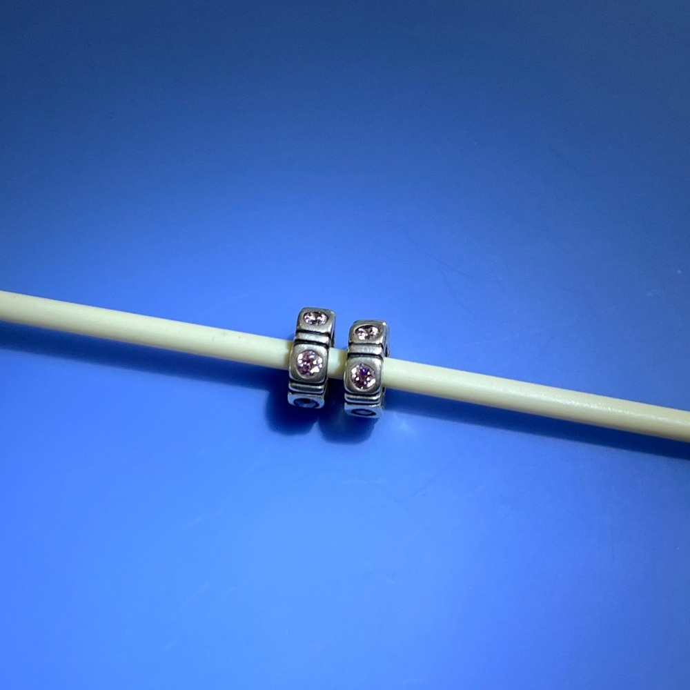 Chamilia set of 2 sterling silver spacer beads with pink cubic zirconia stones.